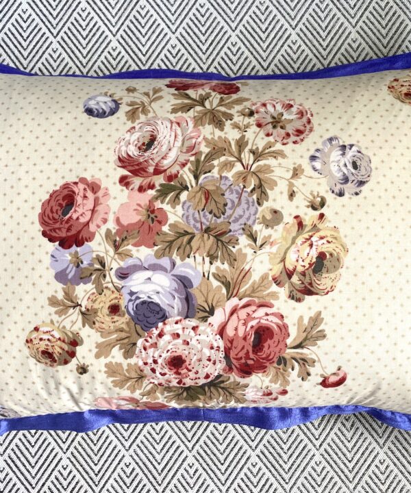 A vintage floral chintz cushion with a royal blue silk trim and tartan reverse (not shown).