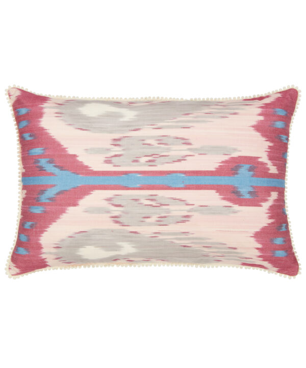 Rectangular silk Ikat cushion in deep pinks and blue with bobble trim.