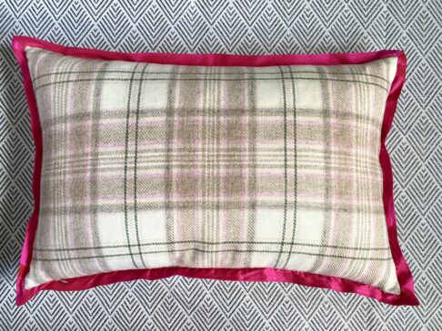 A cream, green and soft pink check cushion reverse with hot pink silk trim.