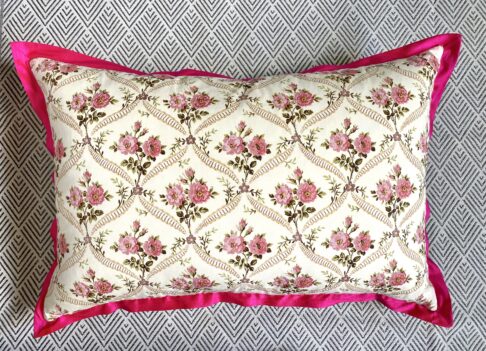 Rectangular vintage rosebud print floral cushion cover with hot pink, silk trim.