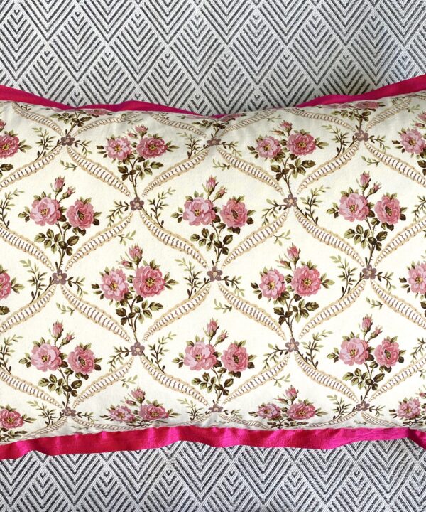 Rectangular vintage rosebud print floral cushion cover with hot pink, silk trim.