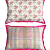 Vintage floral cushions in hot pink showing the rosebud trellis front and pink plaid reverse.