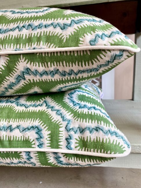 Two piped, green linen cushions, hand-printed in a Moorish Maze design.