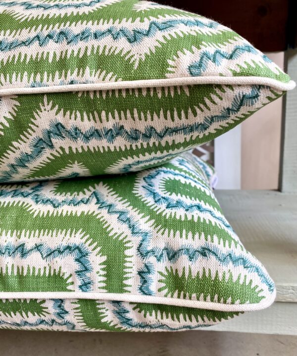 Two piped, green linen cushions, hand-printed in a Moorish Maze design.