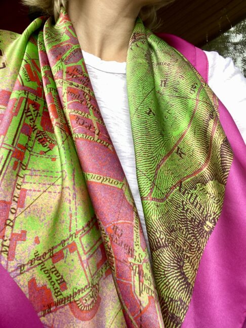 A model wearing with vintage Edinburgh map lime green and magenta pink silk scarf.