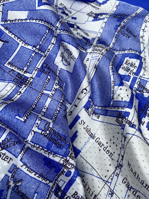 A blue and while luxury silk scarf showcasing a vintage map of Oxford, England.