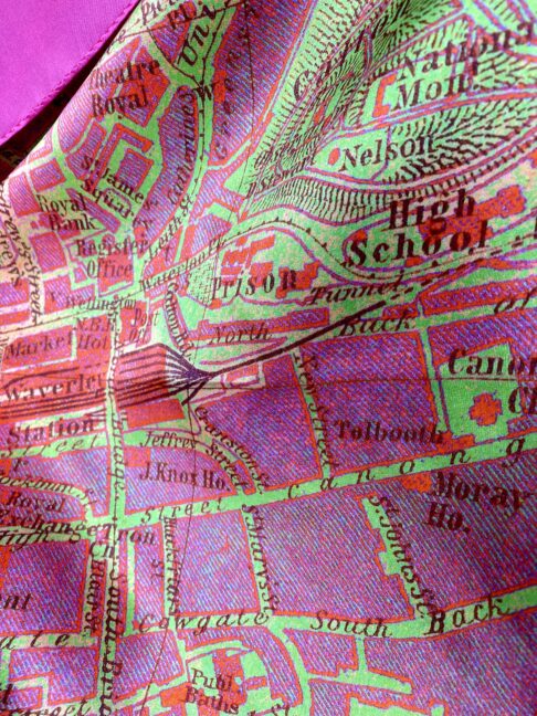 A pink and green luxury silk scarf depicting a vintage map of the city streets of Edinburgh, Scotland.