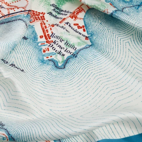 Detail of a luxury silk scarf depicting a map of Hong Kong.