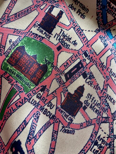 Detail of Paris streets on a silk scarf printed with a vintage map of the city.
