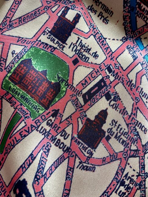 Detail of Paris streets on a silk scarf printed with a vintage map of the city.