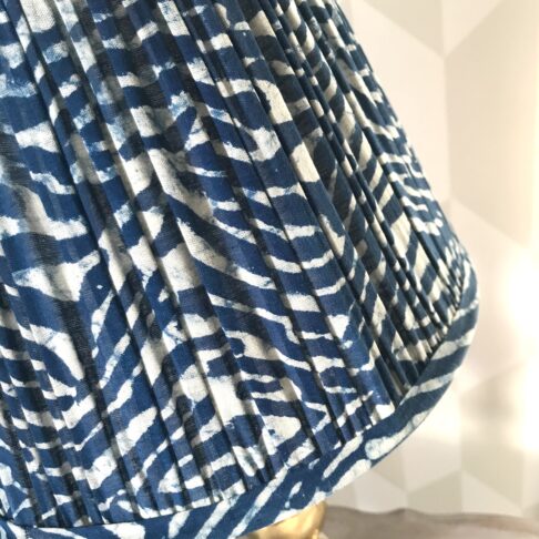 Detail of an indigo, pleated-cotton lamp base.