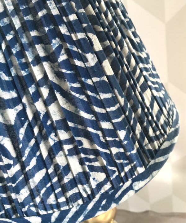 Detail of an indigo, pleated-cotton lamp base.