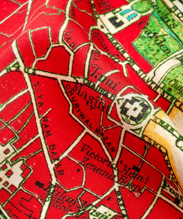 Close-up detail on a red silk scarf printed with a map of Delhi.