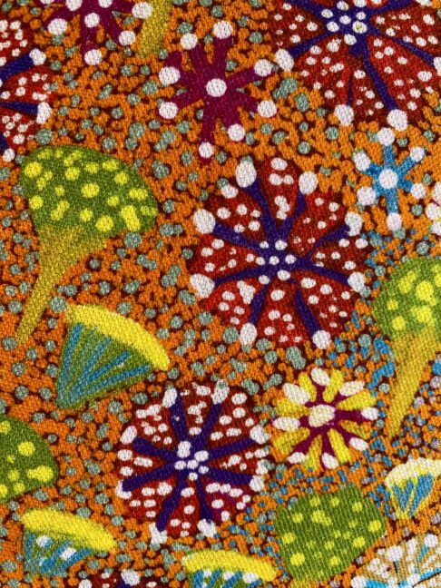 Brightly-coloured linen print of an original Aboriginal art canvas depicting a bush flora.