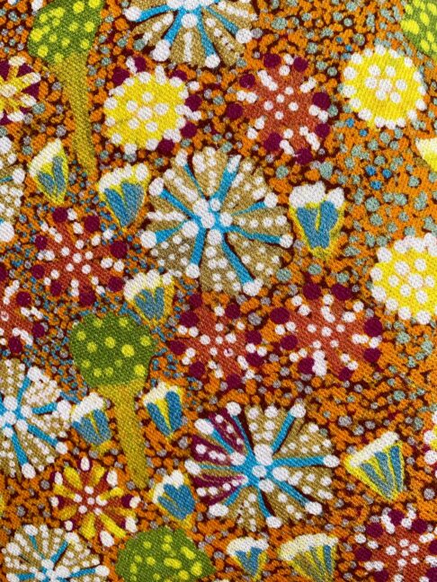 Indigenous Aboriginal art fabric close-up in bold colours.