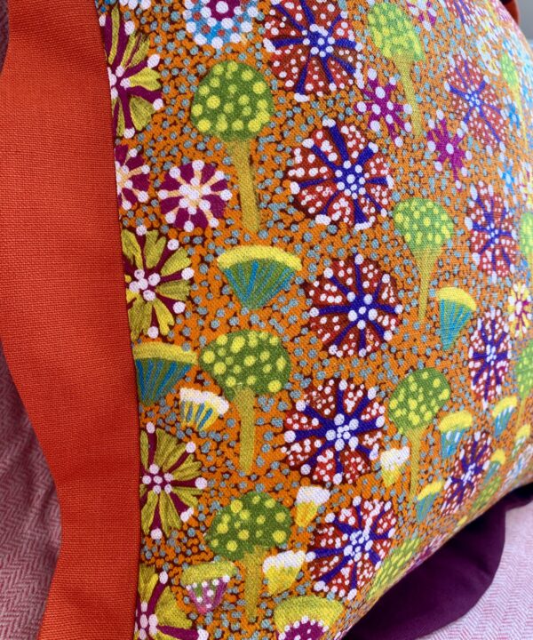 Close-up of floral Aboriginal art print on linen in bright and bold colours.