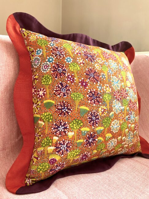 Colourful cushions in orange, burgundy, green and yellow with a botanical print on linen.