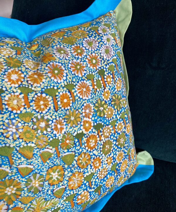 Bold yellow flowers on a cheerful indigenous Aboriginal art print cushion handmade in linen. Turquoise and green scalloped Oxford trim.