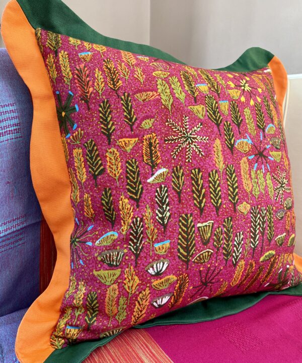 Boldly colourful multi-coloured cushions with a scalloped trim in pink, green and orange with an Aboriginal art printed on linen.