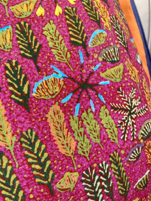 Close-up detail of a pink Aboriginal art linen fabric.