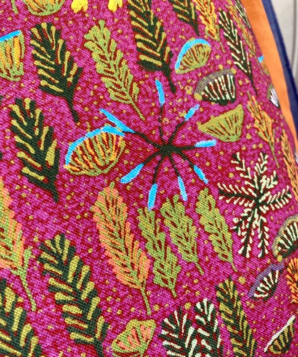 Close-up detail of a pink Aboriginal art linen fabric.