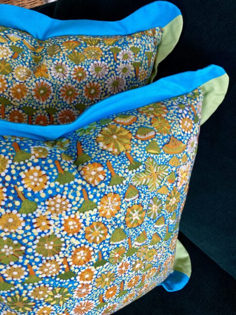 Botanical art print cushion bright turquoise, Spring greens and yellows.