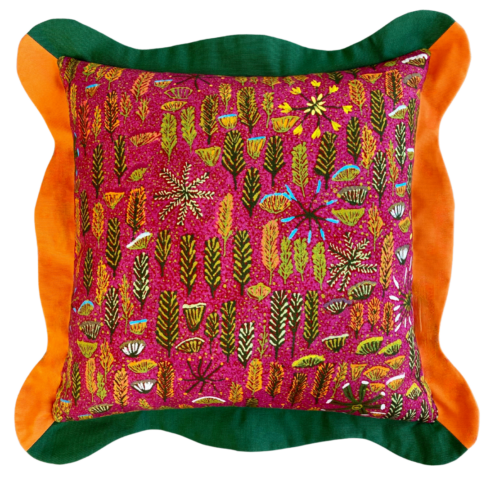 A cut out shot of a scallop-edged cushion with a pink botanical print design taken from Aboriginal artwork.