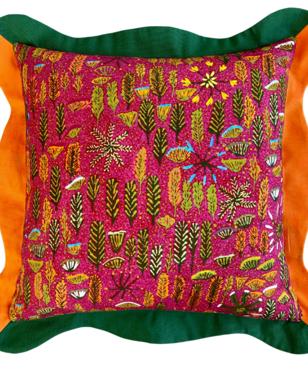 A cut out shot of a scallop-edged cushion with a pink botanical print design taken from Aboriginal artwork.