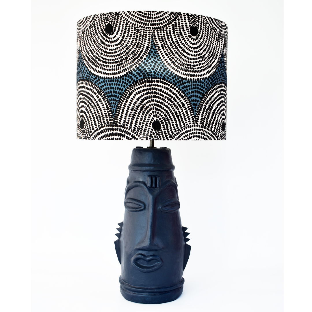 A blue resin table lamp by Kinkatou Studioi nspired by Zulu masks teamed with a blue African fabric drum shade by Porcupine Rocks.