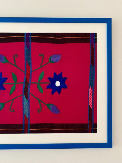 A hot pink and blue Mexican embroidery framed in Royal blue.