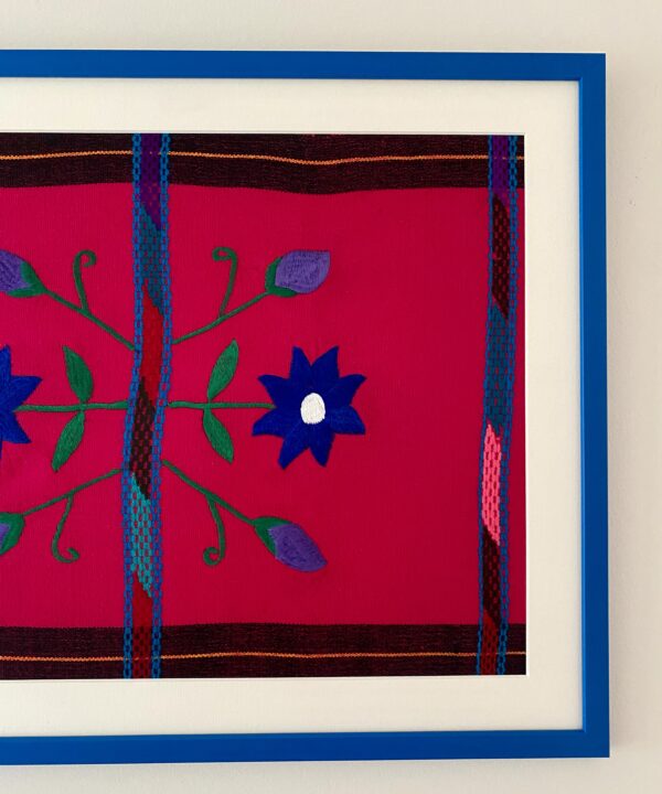 A hot pink and blue Mexican embroidery framed in Royal blue.