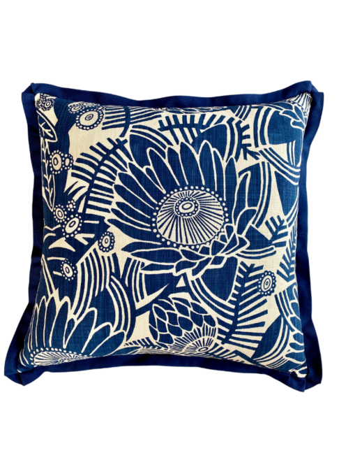 Navy blue floral cushion covers with a Protea flower print and coordinating blue trim.