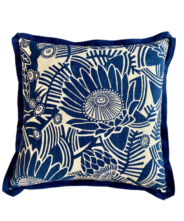 Navy blue floral cushion covers with a Protea flower print and coordinating blue trim.