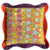 Colourful cushions in tropical colours depicting Aboriginal artwork on linen with scallop edge trims.