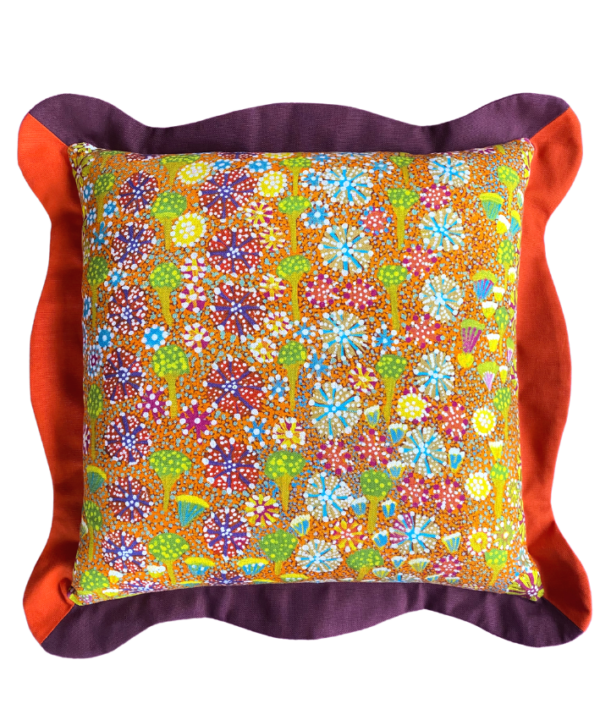 Colourful cushions in tropical colours depicting Aboriginal artwork on linen with scallop edge trims.