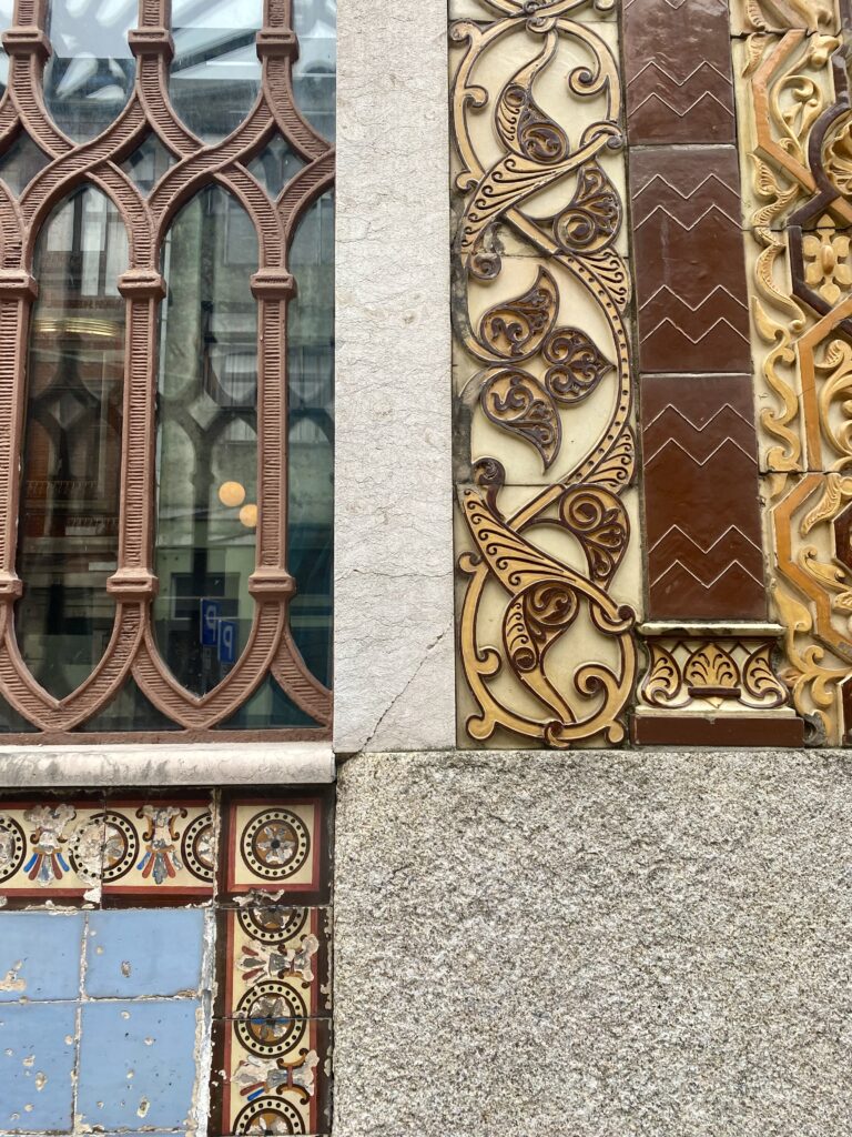 Examples of the Moorish-inspired tradition of decorative relief tiles adorning buildings in Porto, Portugal.