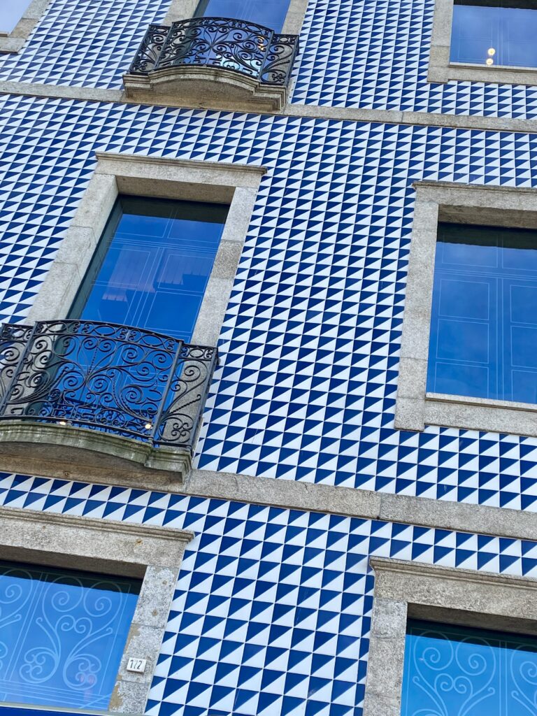 The blue and white tiled facade of a building in the old town in Porto, Portugal.