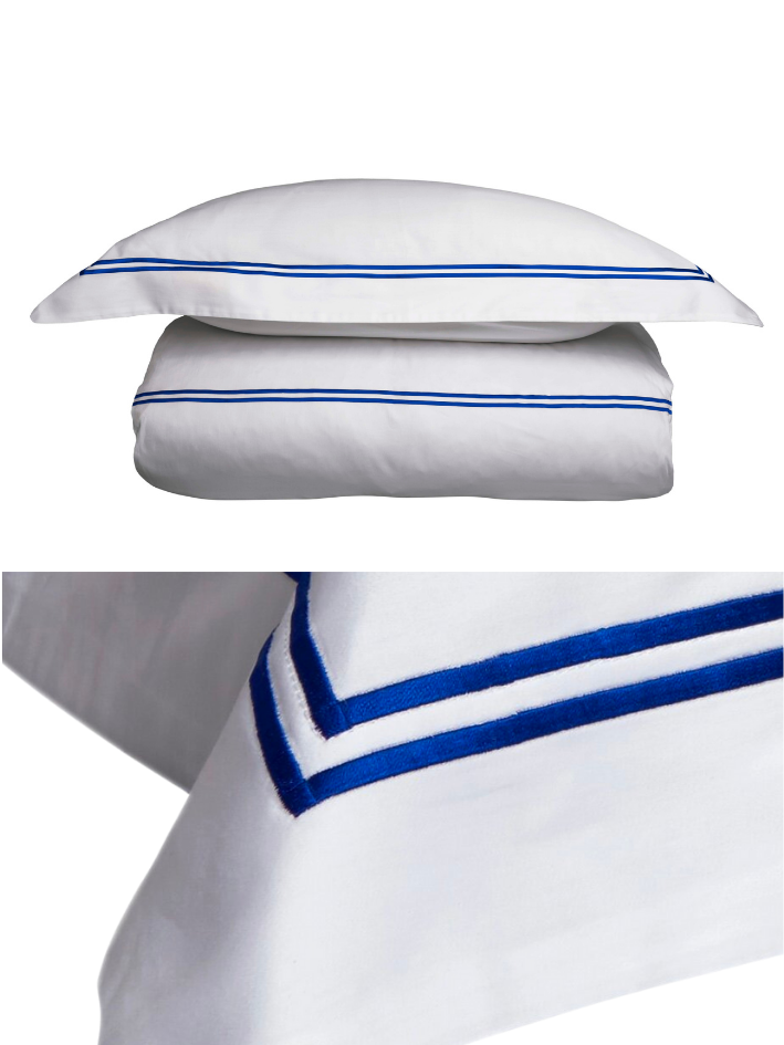 White cotton bedlinen with Royal blue cord stitching detail from The Cotton Poet.