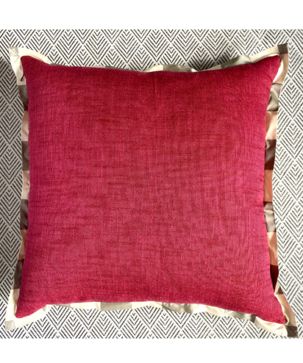 The reverse of a country floral cushion cover in red weave with neutral silk trim.