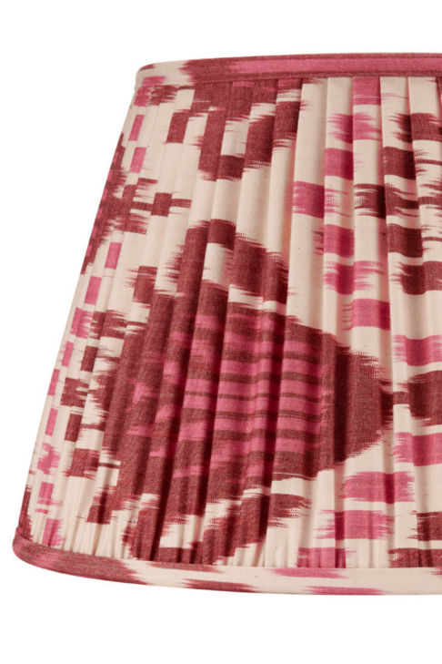 A burgundy silk lampshade with an Ikat design.