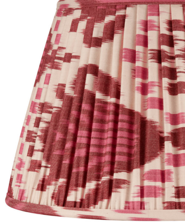 A burgundy silk lampshade with an Ikat design.