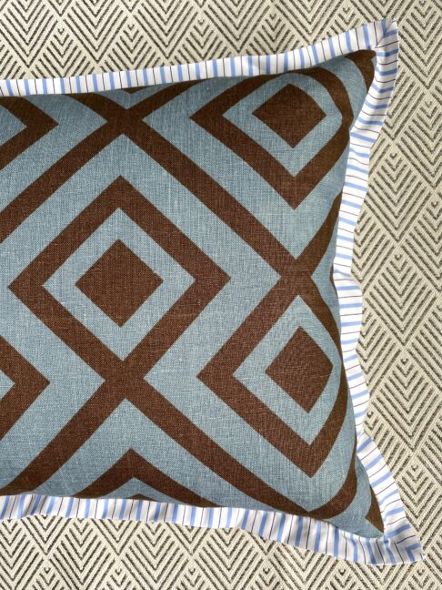 Geometric linen print reverse of a cushion in blue and brown.