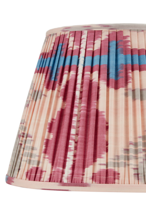 A deep pink silk Ikat lampshade with blue and neutral accents.