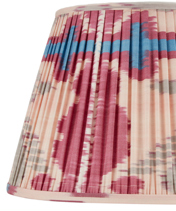 A deep pink silk Ikat lampshade with blue and neutral accents.