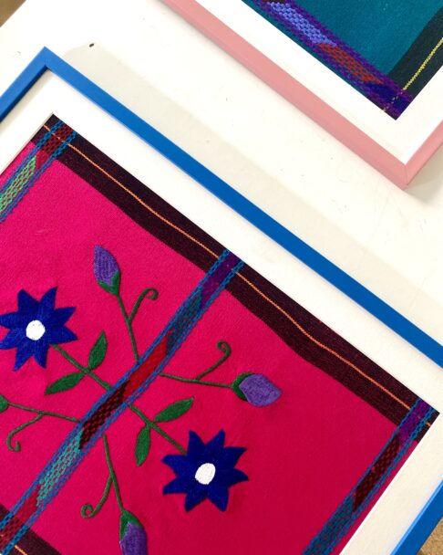 Close-up of a Royal framed Mexican textile in blue and hot pink.