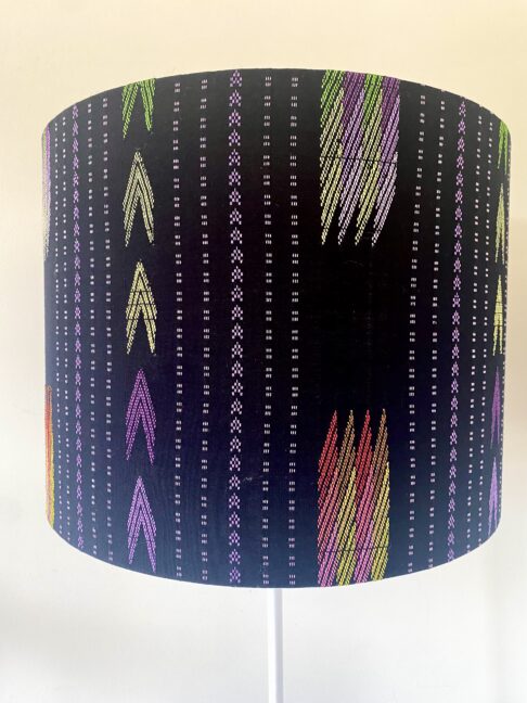 Black lampshade with eclectic, South East Asian pattern detailing.