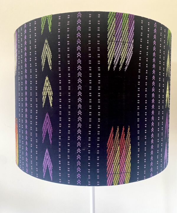 Black lampshade with eclectic, South East Asian pattern detailing.