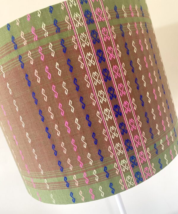 A chic green, pink and blue patterned lampshade with delicate stitched detailing.