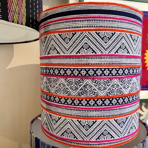 Patterned lampshades with a zig-zag indigo print and hot pink and orange stripes.