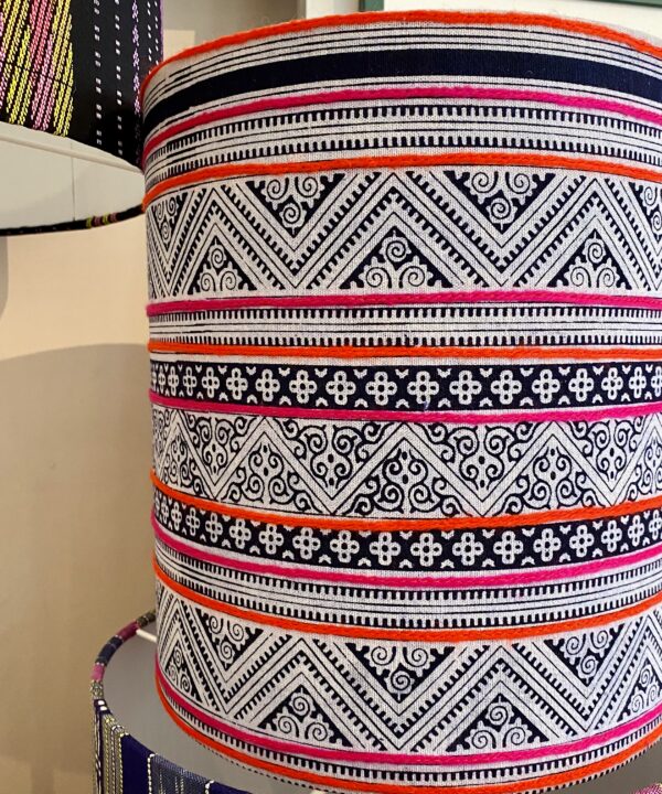 Patterned lampshades with a zig-zag indigo print and hot pink and orange stripes.